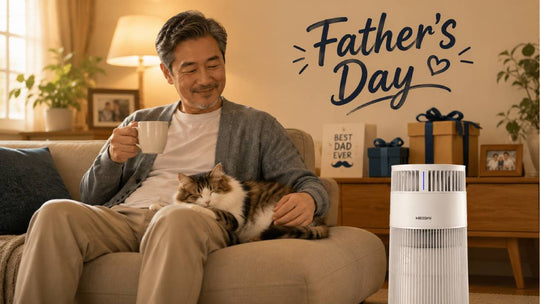 Dad relaxing on couch with cat on lap and air purifier nearby, Father‘s Day gift guide