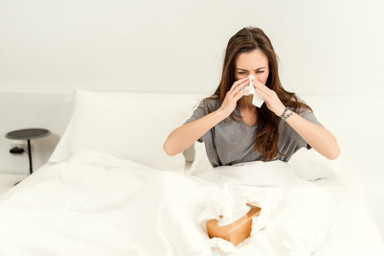 Person sneezing during allergy season needing air purification